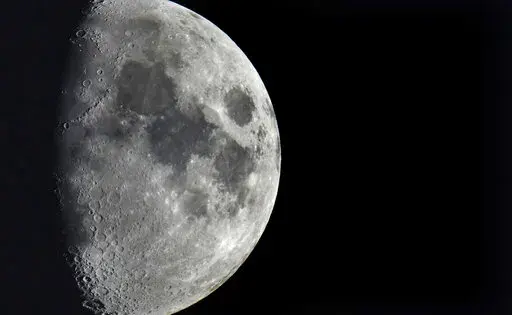 Impact craters cover the surface of the moon, seen from Berlin, Germany, Tuesday, Jan. 11, 2022. The moon is about to get walloped by 3 tons of space junk, a punch that will carve out a crater that could fit several semitractor-trailers. A leftover rocket is expected to smash into the far side of the moon at 5,800 mph (9,300 kph) on Friday, March 4, 2022, away from telescopes’ prying eyes. It may take weeks, even months, to confirm the impact through satellite images. (AP Photo/Michael Sohn, F