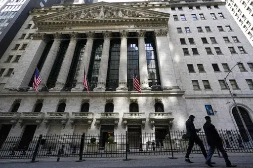 Pedestrians walk past the New York Stock Exchange in New York's Financial District, on March 23, 2021.  Stocks are off to a mixed start on Wall Street Friday, Jan. 7, 2022 as weakness in technology stocks again weighs on the broader market.  (AP Photo/Mary Altaffer, File)