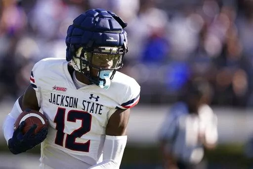 Travis Hunter (12) catches a pass in the first half of Jackson State's spring football game April 24, 2022, in Jackson, Miss. Hunter was likely the most talked about recruit in the 2022 class, if not before signing day, certainly after when he opted to play at Jackson State. The two-way player from Suwanee, Ga., became the first five-star recruit to sign with an FCS school since the ratings system was developed, and the first to sign with a program in the Historically Black College and Universit