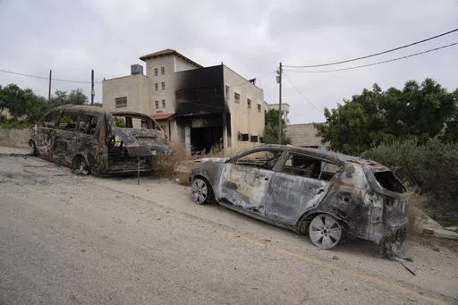 House and vehicles of Ibrahim Dawabsha and his family that were torched during an attack by Israel settlers last month, in the West Bank village of Duma, Tuesday, April 30, 2024. (AP Photo/Nasser Nasser)