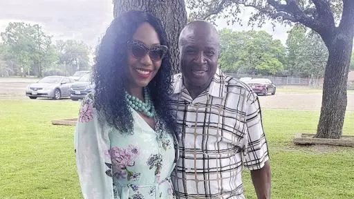 This undated photo provided by Carla Gates shows Gates and her husband, Dallas mail carrier Eugene Gates Jr. On June 20, 2023, Eugene Gates collapsed on a homeowner’s property when he was making deliveries on a suffocating hot day and later died at a hospital. (Courtesy of Carla Gates via AP)