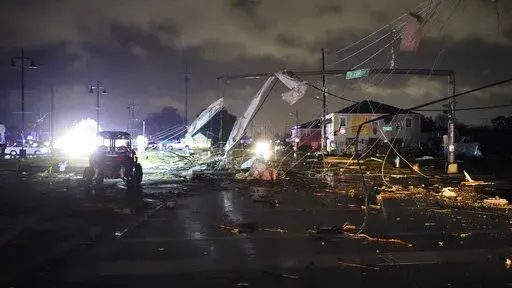 A debris lined street is seen in the Lower 9th Ward, Tuesday, March 22, 2022, in New Orleans, after strong storms moved through the area. (AP Photo/Gerald Herbert)