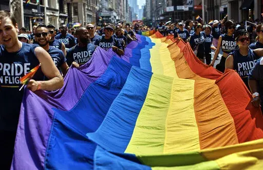 Reveler carry a LTBGQ flag along Fifth Avenue during the New York City Pride Parade on Sunday, June 24, 2018, in New York. Parades celebrating LGBTQ pride kick off in some of America's biggest cities Sunday amid new fears about the potential erosion of freedoms won through decades of activism. The annual marches in New York, San Francisco, Chicago and elsewhere take place just two days after one conservative justice on the Supreme Court signaled, in a ruling on abortion, that the court should re