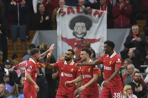 Liverpool's Mohamed Salah, centre, celebrates with teammates after scoring his side's second goal during the English Premier League soccer match between Liverpool and Brentford at Anfield Stadium, Liverpool, England, Sunday, Aug. 25, 2024. (AP Photo/Rui Vieira, File)