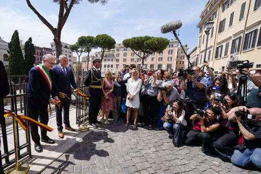 Rome's Mayor Roberto Gualtieri, left, and Bulgari CEO Jean-Christophe Babin cut the ribbon to inaugurate the walkways and nighttime illumination of the so called 'Sacred Area' where four temples, dating back as far as the 3rd century B.C., stand smack in the middle of one of modern Rome's busiest crossroads, Monday, June 19, 2023, With the help of funding from Bulgari, the luxury jeweler, the grouping of temples can now be visited by the public that for decades had to gaze down from the bustling