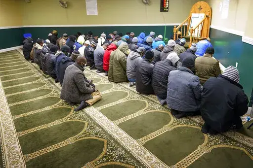 Members of the Masjid Ar Rahman pray, in the Bronx borough of New York, Wednesday, Jan. 12, 2022. The Mosque is a place of worship for some of the residents of the building which suffered the New York City's deadliest fire in three decades. (AP Photo/Mary Altaffer)