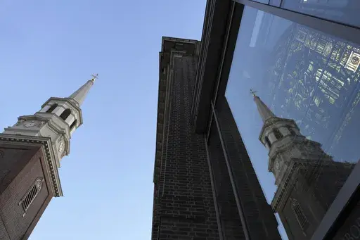 The Christ Church steeple is reflected on “Liberty Window,” a stained-glass window depicting the First Prayer of Congress on display located at the church Neighborhood House in Philadelphia on Sunday, Oct. 6, 2024. (AP Photo/Luis Andres Henao)