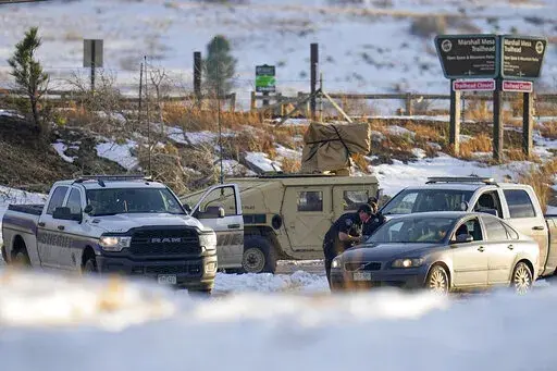 Boulder County Sheriff's officers work a road block at the suspected origin of the Marshall wildfire Monday, Jan. 3, 2022, in Boulder, Colo. (AP Photo/Jack Dempsey)