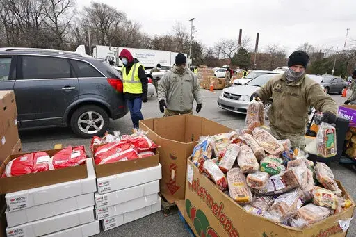 Sgt. Kevin Fowler organizes food at a food bank distribution by the Greater Cleveland Food Bank, Thursday, Jan. 7, 2021, in Cleveland. Food banks across America say these economic conditions are pushing demand for their support higher, at a time when their labor and delivery costs are climbing and donations are decreasing. The problem has grown to the point that President Joe Biden called for a Conference on Hunger, Nutrition and Health in September, the first since 1969/ (AP Photo/Tony Dejak, F