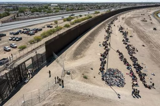 Migrants form lines outside the border fence waiting for transportation to a U.S. Border Patrol facility in El Paso, Texas, May 10, 2023. Washington's center of gravity on immigration has shifted demonstrably to the right. The debate is now focused on measures meant to keep migrants out as Republicans sense they have the political upper hand. A bipartisan group of senators tasked with finding a border deal this week is running out of time to reach an agreement. (AP Photo/Andres Leighton, File)