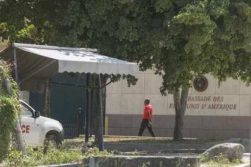 A man enters the U.S. embassy in Port-au-Prince, Haiti, Sunday, March 10, 2024. A charter flight carrying dozens of U.S. citizens fleeing spiraling gang violence in Haiti landed Sunday, March 17, 2024, in Miami, U.S. State Department officials said. (AP Photo/Odelyn Joseph. File)