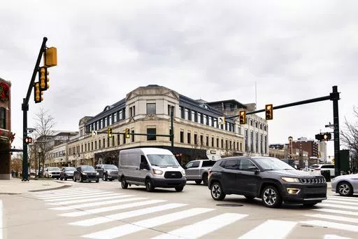 This undated photo provided by the University of Michigan College of Engineering shows vehicles as they drive through the Old Woodward Avenue and East Maple signalized intersection, which was retimed using the Optimized Signal as a Service (OSaaS), in Birmingham, Mich. Smarter vehicles could mean some of the most dramatic changes for the traditional traffic signal since the yellow light was added more than a century ago. (Jeremy Little/University of Michigan College of Engineering via AP)