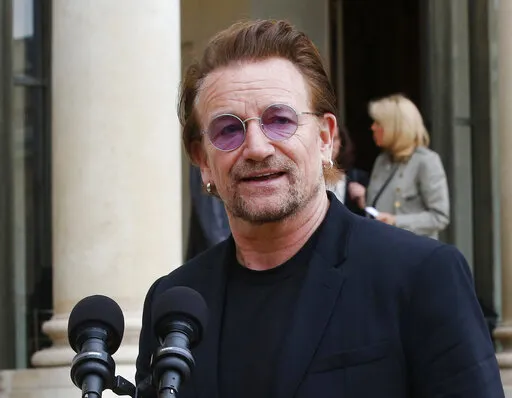 U2 singer Bono speaks to the media after a meeting at the Elysee Palace, in Paris, France on July 24, 2017.  Bono's memoir "Surrender" planned for release on Nov. 1. (AP Photo/Michel Euler, File)