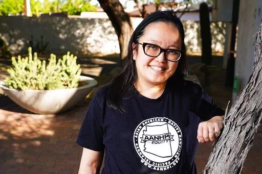 Jennifer Chau, director of the Arizona Asian American Native Hawaiian and Pacific Islander For Equity Coalition, at her office Friday, April 8, 2022, in Tempe, Ariz. (AP Photo/Ross D. Franklin)