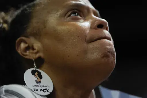 A supporter wearing earrings that read "Unapologetically Black" listens during a campaign rally for Democratic presidential nominee Vice President Kamala Harris, Aug. 10, 2024, in Las Vegas. (AP Photo/Julia Nikhinson, File)