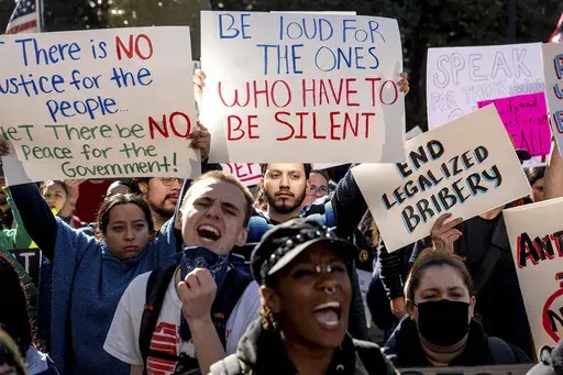 Michael Martinez joins several hundred demonstrators rallying against President Donald Trump outside the California State Capitol on Wednesday, Feb. 5, 2025, in Sacramento, Calif. (AP Photo/Noah Berger)