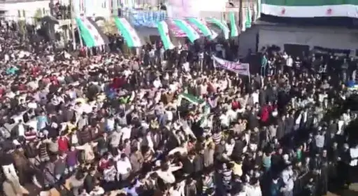 In this image from amateur video made available by the Ugarit News group and shot on Friday, Dec. 30, 2011, protesters gather at an anti-Syrian president Bashar Assad rally in Hama, Syria. (AP Photo/Ugarit News Group via APTN, File)
