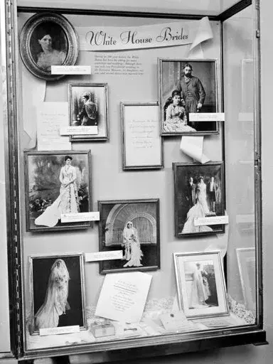 Photographs of brides married in the White House are displayed in the executive mansion in a glass-enclosed case in Washington, Aug. 1, 1966 prior to Saturday wedding of Luci Baines Johnson, President Johnson's youngest daughter. Down the left side of the frame, top the bottom, are: President James Monroe's daughter, Maria; President Rutherford B. Haye's niece, Emily Platt, Miss Frances Folsom, married to President Grover Cleveland; and President Woodrow Wilson's daughter, Eleanor. At center, Pr