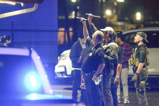Police investigate the scene of a shooting that wounded several people Saturday, Dec. 2, 2023, in McComb, Miss. (Matt Williamson/The Enterprise-Journal via AP)