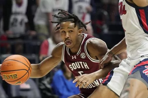 South Carolina guard Meechie Johnson (5) attempts to dribble past a Mississippi player during the first half of an NCAA college basketball game, Saturday, Feb. 24, 2024, in Oxford, Miss. (AP Photo/Rogelio V. Solis)