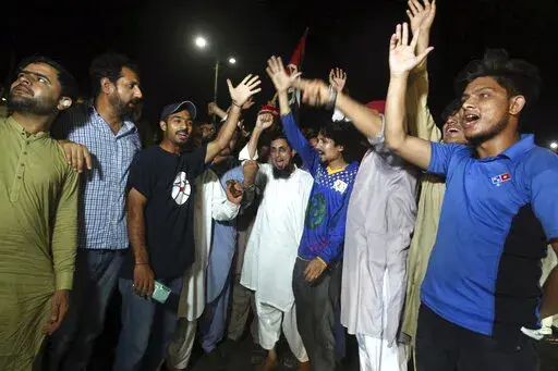 Supporters of an opposition party celebrate the success of a no-confidence vote against Prime Minister Imran Khan, in Karachi, Pakistan, Sunday, April 10, 2022. Pakistan's political opposition toppled Prime Minister Khan in a no-confidence vote in Parliament early Sunday after several political allies and a key party in his ruling coalition deserted him. (AP Photo/Fareed Khan)