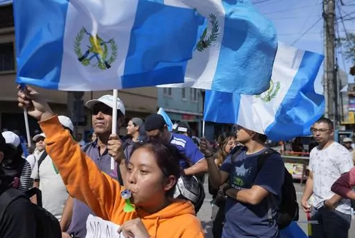 Demonstrators protest in front of Guatemala's Attorney General's office building in Guatemala City, Thursday, July 13, 2023. The Attorney General's Office announced on July 12 that a judge had suspended the legal status of the Seed Movement political party for alleged violations when it gathered the necessary signatures to form. The party's presidential candidate had been set to compete in a runoff election on Aug. 20. (AP Photo/Moises Castillo)