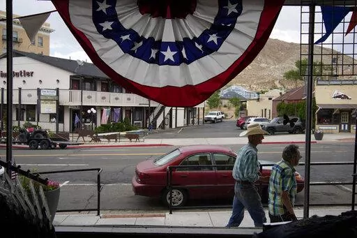 People walk along the main drag in the county seat of Nye County on July 18, 2022, in Tonopah, Nev. The American Civil Liberties Union of Nevada asked the state's secretary of state Wednesday, Nov. 2 to formally investigate allegations of partisan improprieties in a hand-count of advance election ballots that's currently on hold in rural Nye County after a state Supreme Court ruling raised questions about the legality of the process last week. (AP Photo/John Locher, File)