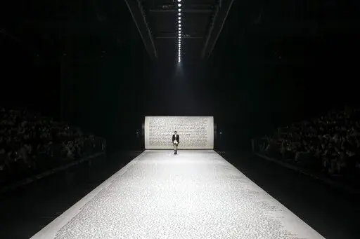 A model wears a creation as part of Dior Men's fashion collection presented in London, Thursday, Dec. 9, 2021. (Photo by Vianney Le Caer/Invision/AP)