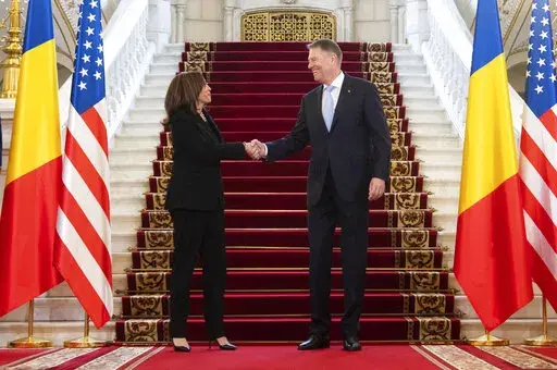 Romanian President Klaus Iohannis shakes hands with US Vice President Kamala Harris as she arrives for a meeting at Cotroceni Palace in Otopeni, Romania, Friday, March 11, 2022. (Saul Loeb/Pool Photo via AP)