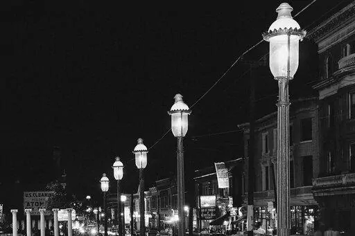 Gas lamps illuminate St. Louis' Gaslight Square on April 2, 1962. "Gaslighting" — mind manipulating, grossly misleading, downright deceitful — is Merriam-Webster's word of 2022. (AP Photo/JMH, File)