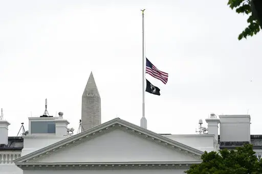 The American flag flies at half-staff at the White House in Washington, Thursday, May 12, 2022, as the Biden administration commemorates 1 million American lives lost due to COVID-19. (AP Photo/Susan Walsh)