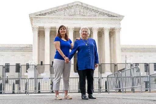 Benita Lubic, 86, of Washington, right, with her daughter Wendie Lubic, 60, pose for a photograph by the Supreme Court, Tuesday, June 21, 2022, in Washington. During a May rally in support of abortion rights, Benita Lubic came to the court with a sign saying, "I don't regret my abortion." Her daughter also had an abortion. "We weren't ready to have children or get married," says Wendie Lubic, who later did marry the same man and they have two daughters. "I had an abortion in 1968," says Benita L