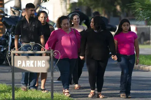 People leave a funeral home after attending a visitation for Amerie Garza, a 10-year-old victim who was killed in last week's elementary school shooting in Uvalde, Texas, Monday, May 30, 2022. (AP Photo/Jae C. Hong)