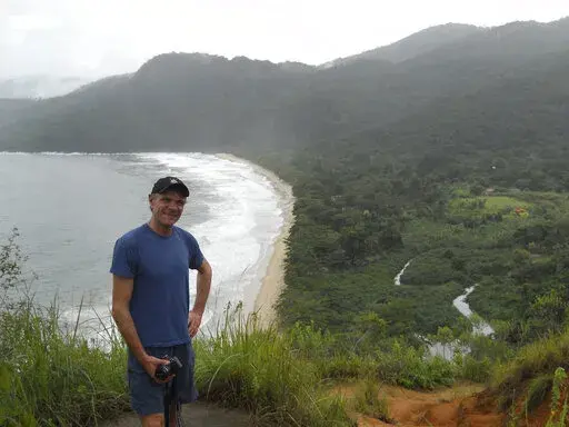 In this photo provided by Tom Hennigan, British Journalist Dom Phillips poses for a photo during a hike in Paraty, Brazil, April 2, 2010. British journalist Dom Phillips’ quest to unlock the secrets of how to preserve Brazil’s Amazon was cut short this June 2022, when he was killed along with a colleague in the heart of the forest he so cherished. (Tom Hennigan via AP)