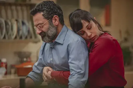 This photo released by Netflix shows characters from the Arabic-language version of the Italian film “Perfect Strangers,” about friends who agree to share their incoming calls, voice and text messages with each other over a dinner party, leading to a series of revelations that test their marriages and friendships. The film’s release has led to a widespread debate in some Arabic-speaking societies, such as Egypt, where some have denounced it as a threat to family and religious values while 