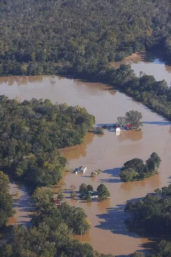 Floodwaters from the Neuse River surround several homes after Hurricane Matthew in the western part of Wayne County near Goldsboro, N.C., Tuesday, Oct. 11, 2016. Nearly six years after extreme rainfall and flooding from Hurricane Matthew damaged many North Carolina homes, some homeowners are still left waiting on repairs. A new bipartisan General Assembly committee tasked with investigating the delays holds its first meeting Wednesday, Sept. 14, 2022, on the four-year anniversary of when Hurrica