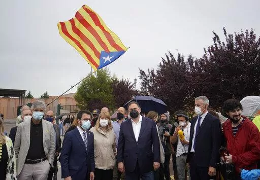Former deputy president of the Catalan regional government Oriol Junqueras, centre, walks with the current Catalonian president Pere Aragones, 2nd left, in front of an "estelada" or Catalan pro-independence flag after being released from the Lledoners prison in Sant Joan de Vilatorrada near Barcelona, Spain, June 23, 2021. The phones of dozens of pro-independence supporters in Spain's northeastern Catalonia, including the regional chief and other elected officials, were hacked with controversial