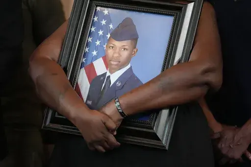 Chantemekki Fortson, mother of slain Roger Fortson, a U.S. Air Force senior airman, holds a photo of her son during a news conference with attorney Ben Crump on Monday, June 3, 2024, in Atlanta. (AP Photo/Brynn Anderson, File)