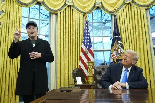 President Donald Trump listens as Elon Musk speaks in the Oval Office at the White House, Tuesday, Feb. 11, 2025, in Washington. (AP Photo/Alex Brandon, File)