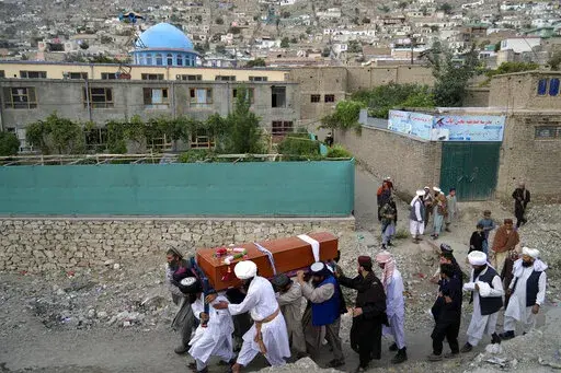 Mourners carry the body of a victim of a mosque bombing in Kabul, Afghanistan, Thursday, Aug. 18. 2022. A bombing at a mosque in Kabul during evening prayers on Wednesday killed at least 10 people, including a prominent cleric, and wounded over two dozen, an eyewitness and police said. (AP Photo/Ebrahim Noroozi)