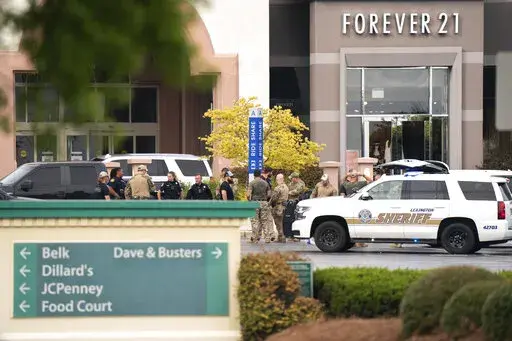 Members of law enforcement gather outside Columbiana Centre mall in Columbia, S.C., following a shooting, April 16, 2022. Authorities in South Carolina say they are investigating shooting at a club in Hampton County early Sunday, April 17, 2022 that left at least nine people injured. It was the second mass shooting in the state in as many days. (AP Photo/Sean Rayford)