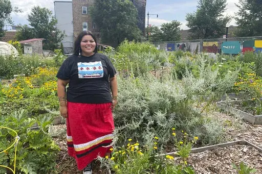 Janie Pochel, an advisor to the Chi-Nations Youth Council, is pictured at the First Nations Garden in Chicago, on Aug. 3, 2022. The garden was established in the spring of 2019 and is host to many traditional Indigenous crops including prairie sage, sweetgrass and strawberries. (Claire Savage/Report for America via AP)