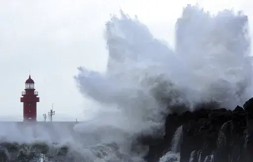Waves crash on the eastern coast of Jeju Island, South Korea, as Typhoon Hinnamnor travels toward the Korean Peninsula on Sunday, Sept. 4, 2022. Cities in eastern China suspended ferry services and classes and flights were canceled in Japan on Sunday as Typhoon Hinnamnor, the strongest global storm this year, blew its way past Taiwan and the Koreas with fierce winds and heavy rains. (Han Sang-kyun/Yonhap via AP)