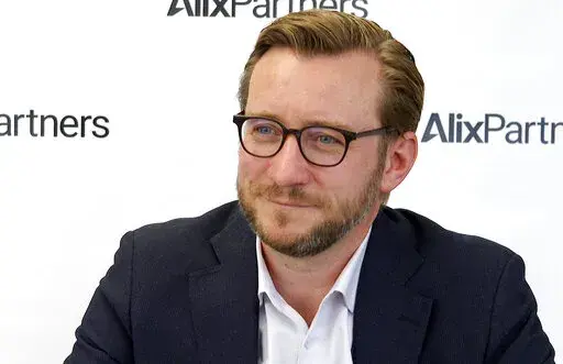 In this Monday, March 21, 2022, image made from video, Mark Wakefield, co-leader of AlixPartners’ global automotive unit, speaks during an interview with The Associated Press at the consulting firm’s offices in Southfield, Mich. Russia’s war on Ukraine is bringing new problems to the global auto industry. As Wakefield said: “You only need to miss one part to not be able to make a car.” (AP Photo/Mike Householder)