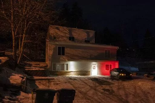 A private security officer sits in a vehicle, Tuesday, Jan. 3, 2023, in front of the house in Moscow, Idaho where four University of Idaho students were killed in November, 2022. Authorities said Wednesday, Jan. 4, that Bryan Kohberger, the man accused in the killings, has left a Pennsylvania jail in the custody of state police. The move means Kohberger could be headed to Idaho to face first-degree murder charges. (AP Photo/Ted S. Warren)
