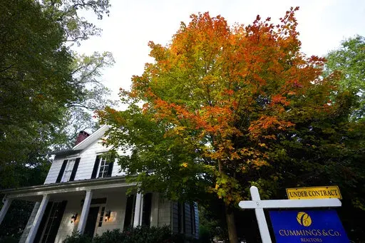 A real estate sign is seen near a home on the market, Wednesday, Oct. 12, 2022, in Towson, Md. Any Americans hoping for relief from months of punishing inflation might not see much in an upcoming government report on price increases in September.  (AP Photo/Julio Cortez)