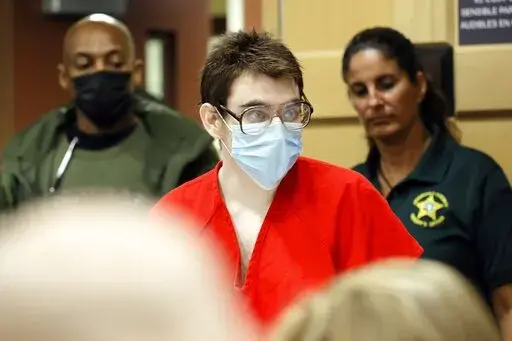 Nikolas Cruz enters the courtroom for a hearing at the Broward County Courthouse in Fort Lauderdale, Fla., on Wednesday, March 29, 2022. Cruz previously plead guilty to all 17 counts of premeditated murder and 17 counts of attempted murder in the 2018 shootings at Marjory Stoneman Douglas High School . (Amy Beth Bennett/South Florida Sun-Sentinel via AP, Pool)
