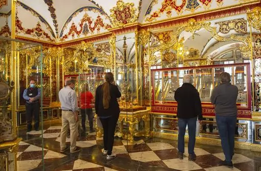 Visitors stand in the Jewel Room during the reopening of the Green Vault Museum in Dresden's Royal Palace of the Dresden State Art Collections (SKD) in Dresden, Germany, May 30, 2020. A German court on Tuesday May 16, 2023, convicted five men of particularly aggravated arson in combination with dangerous bodily injury, theft with weapons, damage to property and intentional arson in the spectacular theft of 18th-century jewels from the Dresden museum in 2019. (AP Photo/Jens Meyer, file)