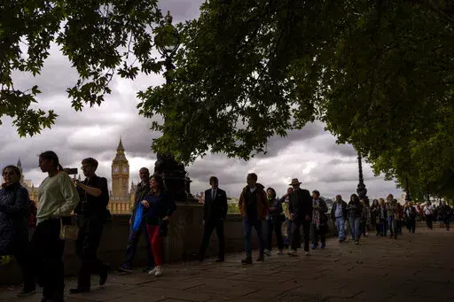 People queue to pay their respect to the late Queen Elizabeth II while she lies in state outside Westminster Hall in London, Sept. 15, 2022.  (AP Photo/Emilio Morenatti, File)