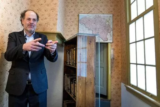 Ronald Leopold, executive director Anne Frank House, gestures as he talks next to the passage to the secret annex during an interview in Amsterdam, Netherlands, Monday, Jan. 17, 2022. A cold case team that combed through evidence for five years may have solved one of World War II's enduring mysteries: Who betrayed Jewish teenage diarist Anne Frank and her family? Their answer, outlined in a new book, is that it most likely was a Jewish lawyer called Arnold van den Bergh. (AP Photo/Peter Dejong)